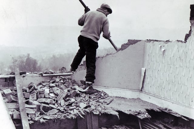 A workman starts demolition work at Brightside Vicarage in Firth Park Avenue, Sheffield, where Mrs Shirley Margaret Hill, wife of the vicar, the Rev Colin Hill, was killed during the gale.  The vicarage was so badly damaged it was beyond repair.