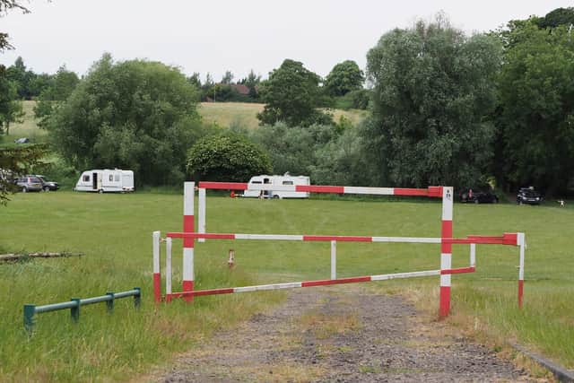 Pictured: Caravans and vehicles behind a gate