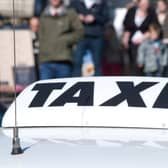 Closeup of taxi cab sign in city centre