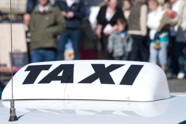 Closeup of taxi cab sign in city centre