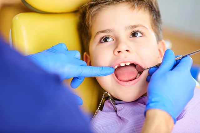 A dentist checking a child's teeth. Picture: Adobe stock