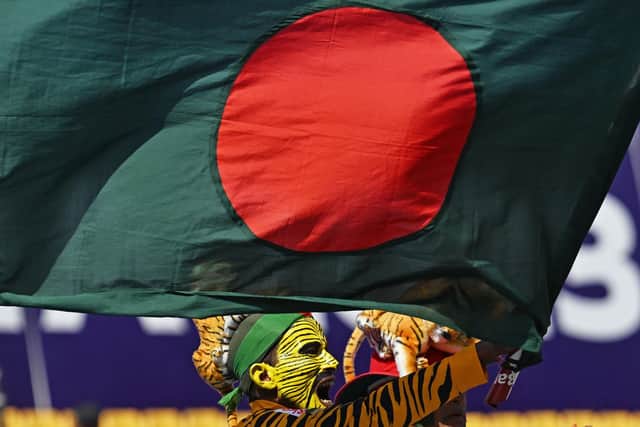 A fan waves Bangladesh's national flag before the start of the 2023 ICC Men's Cricket World Cup one-day international (ODI) match between England and Bangladesh (Photo by ARUN SANKAR/AFP via Getty Images)