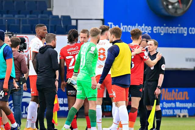 Luton's players and boss Nathan Jones make their point to the officials after the final whistle