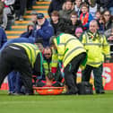 Cohen Bramall is stretchered off against Blackpool this afternoon - pic: David Horn / PRiME Media Images