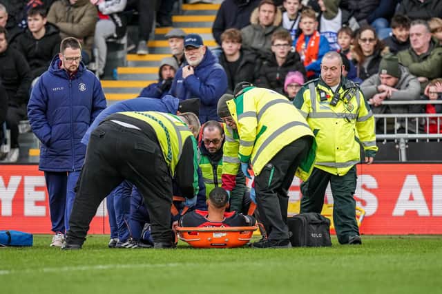 Cohen Bramall is stretchered off against Blackpool this afternoon - pic: David Horn / PRiME Media Images