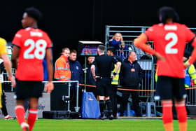 Referee Chris Kavanagh is sent to the screen by VAR at Kenilworth Road - pic: Liam Smith