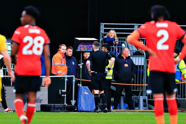 Referee Chris Kavanagh is sent to the screen by VAR at Kenilworth Road - pic: Liam Smith