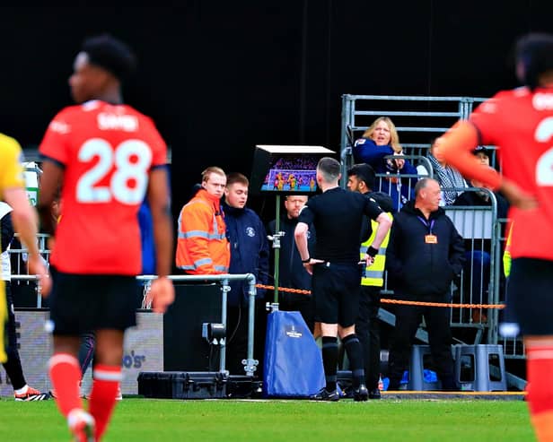 Referee Chris Kavanagh is sent to the screen by VAR at Kenilworth Road - pic: Liam Smith