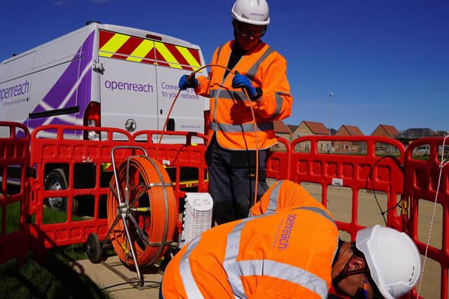 Engineers laying the new fibre cables
