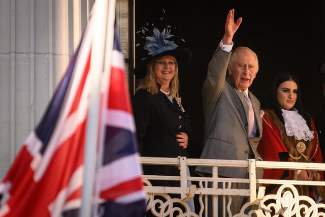 King Charles III waves from the balcony as he visits Luton Town Hall (Photo by Leon Neal/Getty Images)