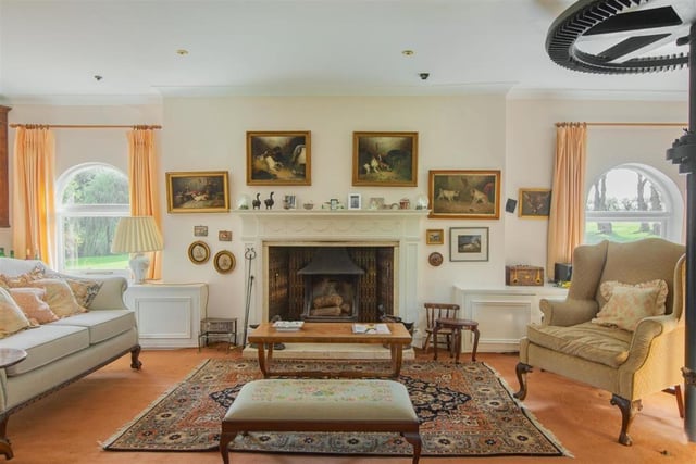 The sitting room has a large fire and big windows - which brings lots of light into the property.