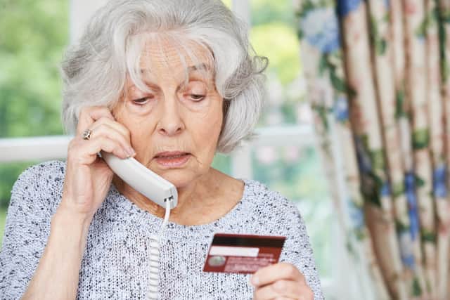 Senior woman giving credit card details on the phone. Picture: Adobe Stock