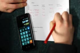 Child uses calculator to solve maths problem. Picture: David Jones via PA