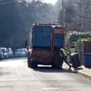 Refuse workers collect bins. Picture: Steve Parsons/PA