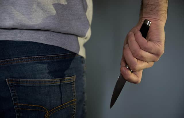A model poses holding a knife (Photo: Andrew Matthews/PA Wire)