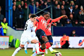 Pelly-Ruddock Mpanzu looks to win the ball against Swansea on Saturday