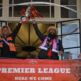 Luton Town's manager Rob Edwards (L) and Luton's mayor Mohammad Yaqub Hanif (R) lift the Championship playoff trophy as Luton Town football club players and staff hold an event in St George's Square as they celebrate their promotion to the English Premier League.  Photo by DANIEL LEAL/AFP via Getty Images)