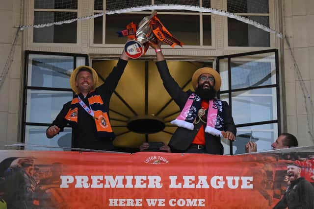 Luton Town's manager Rob Edwards (L) and Luton's mayor Mohammad Yaqub Hanif (R) lift the Championship playoff trophy as Luton Town football club players and staff hold an event in St George's Square as they celebrate their promotion to the English Premier League.  Photo by DANIEL LEAL/AFP via Getty Images)