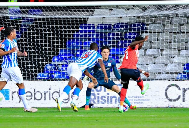 Town striker Elijah Adebayo saw this effort count as his first goal of the season despite deflecting in off Huddersfield defender Michal Helik