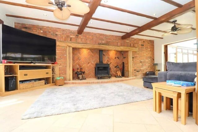 The living space features a stunning brick built inglenook fireplace