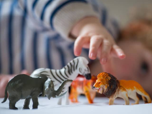Preschool age child playing with plastic toy animals. Picture: Dominic Lipinski/PA Wire