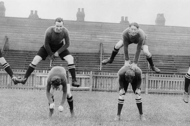 Luton Town footballers in training on 28th August 1926. Jumping, from left to right, Harkins, Gordon, Clarke and Moir. Bending, from left to right, Wolstenholme, Black, Dennis and Pointon.  (Photo by Cooper /Topical Press Agency/Getty Images)