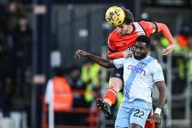 Hatters defender Tom Lockyer gets up to head the ball away from Crystal Palace forward Odsonne Edouard - pic: JUSTIN TALLIS/AFP via Getty Images
