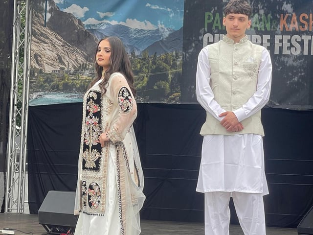 Models pose on a catwalk in traditional Pakistani outfits by Bliss Boutique and Memsaab at the Pakistan and Kashmir Culture Festival.