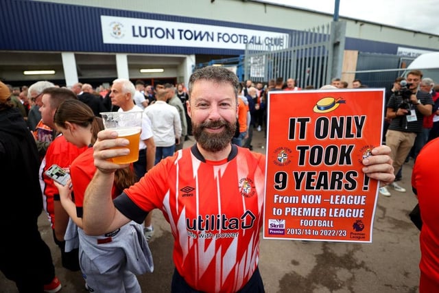 A Luton supporter celebrates being back in the top flight.