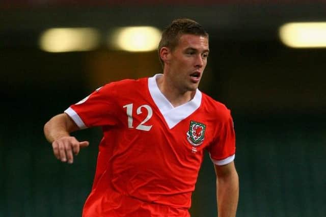 New Luton manager Rob Edwards in action for Wales during his international career