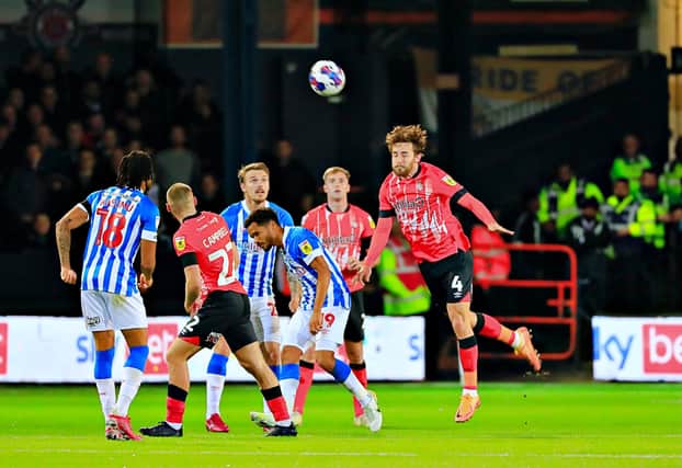 Tom Lockyer with a headed clearance against Huddersfield recently