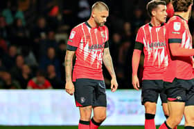 Hatters midfielder Henri Lansbury was withdrawn at half time on Tuesday night
