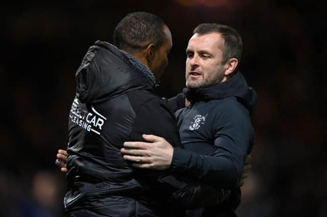 Hatters boss Nathan Jones greets Reading manager Paul Ince before the game