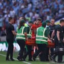 Luton defender Tom Lockyer is stretchered off at Wembley