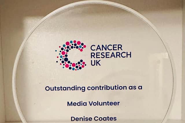 The glass plaque Denise received citing her outstanding contribution as a media volunteer for Cancer Research UK