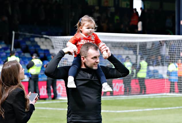 Hatters boss Nathan Jones celebrates reaching the play-offs with his daughter