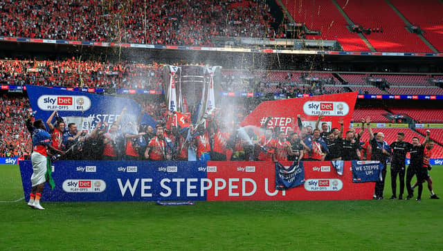 Hatters' players lift the trophy at Wembley Stadium