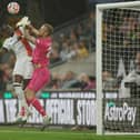 Elijah Adebayo looks to win a header under pressure from Wolves keeper Daniel Bentley - pic: Eddie Keogh/Getty Images