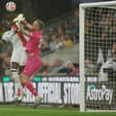 Elijah Adebayo looks to win a header under pressure from Wolves keeper Daniel Bentley - pic: Eddie Keogh/Getty Images