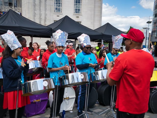 Outside of the town hall, a steel pan band performed during the day.