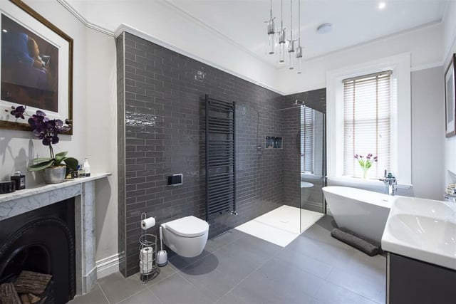 The bathroom is one of five in the house - complete with a walk-in shower and a bath