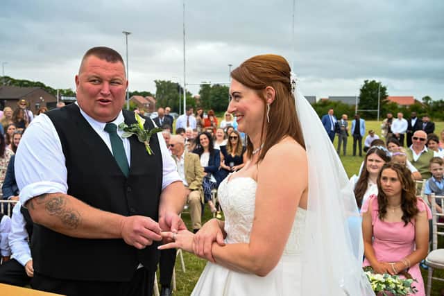 The couple exchanging rings. Picture: John Chatterley