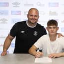 Luca Thomas signs his professional contract with the Hatters - pic: Luton Town FC