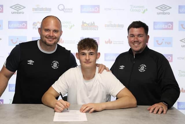 Luca Thomas signs his professional contract with the Hatters - pic: Luton Town FC