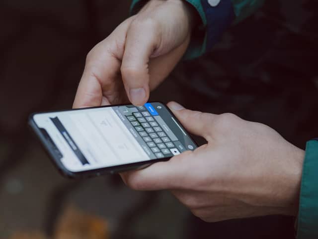 A person holding a mobile phone. Picture: Unsplash.