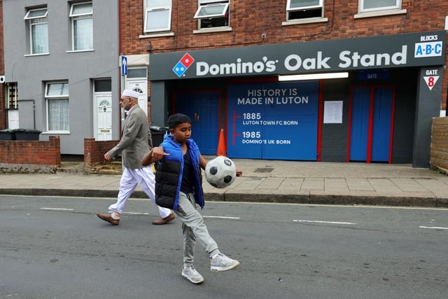 A Luton youngster shows off his skills outside the ground.