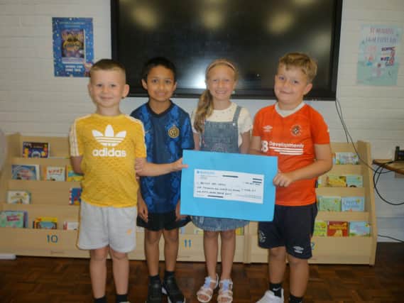 Kids with the cheque for the British Red Cross. Picture: Luton Borough Council