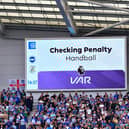 Luton's penalty at Brighton is checked by VAR at the weekend - pic: Liam Smith