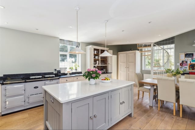 An open-plan kitchen is a must-have for a family who likes entertaining. The spacious kitchen and breakfast room was fitted by luxury designer Martin Moore and features a range of bespoke units, a central island and traditional Aga.