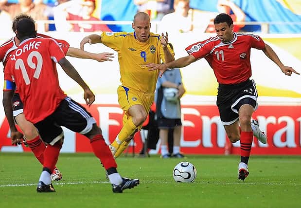 Former Luton winger Carlos Edwards goes up Swedish midfielder Freddie Ljungberg during their Group B clash in the 2006 World Cup
